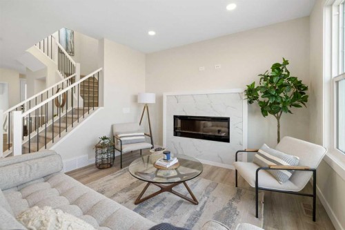 450 Kinniburgh Loop, Chestermere, AB - Indoor Photo Showing Living Room With Fireplace