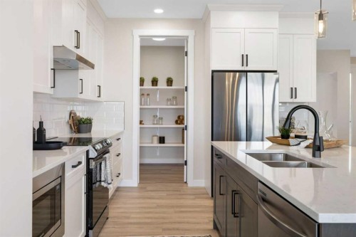 450 Kinniburgh Loop, Chestermere, AB - Indoor Photo Showing Kitchen With Double Sink With Upgraded Kitchen