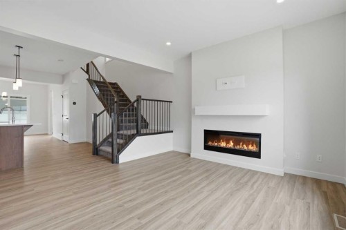80 Buffaloberry Manor Se, Calgary, AB - Indoor Photo Showing Living Room With Fireplace