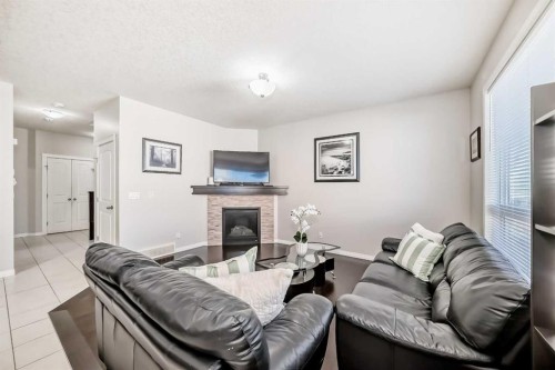 795 New Brighton Drive Se, Calgary, AB - Indoor Photo Showing Living Room With Fireplace