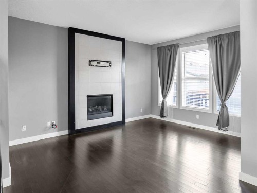 23 Marquis Link Se, Calgary, AB - Indoor Photo Showing Other Room With Fireplace