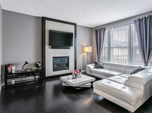 23 Marquis Link Se, Calgary, AB - Indoor Photo Showing Living Room With Fireplace