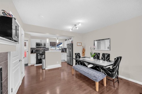 207 Elgin Meadows Gardens Se, Calgary, AB - Indoor Photo Showing Dining Room With Fireplace