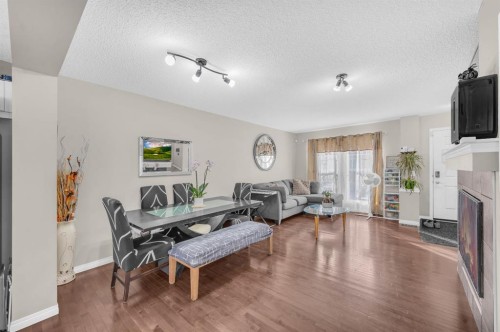 207 Elgin Meadows Gardens Se, Calgary, AB - Indoor Photo Showing Other Room With Fireplace