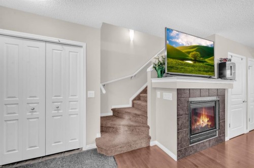 207 Elgin Meadows Gardens Se, Calgary, AB - Indoor Photo Showing Other Room With Fireplace