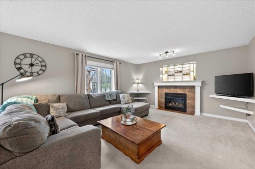 127 Hidden Ranch Terrace Nw, Calgary, AB - Indoor Photo Showing Living Room With Fireplace