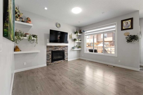 439 Bayview Way Sw, Airdrie, AB - Indoor Photo Showing Living Room With Fireplace