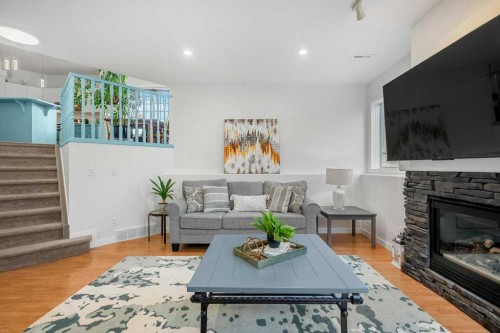 195 Somerglen Common Sw, Calgary, AB - Indoor Photo Showing Living Room With Fireplace