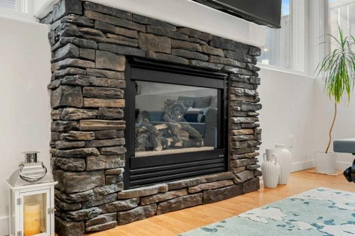 195 Somerglen Common Sw, Calgary, AB - Indoor Photo Showing Living Room With Fireplace
