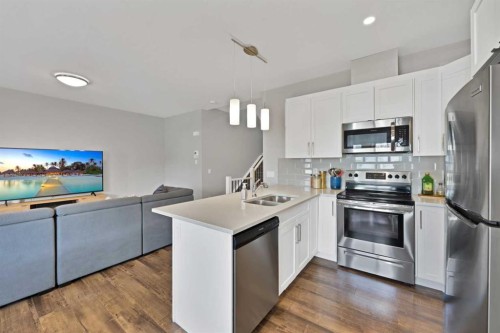 1167 Channelside Drive Sw, Airdrie, AB - Indoor Photo Showing Kitchen With Double Sink With Upgraded Kitchen