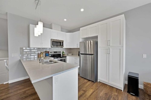 1167 Channelside Drive Sw, Airdrie, AB - Indoor Photo Showing Kitchen With Double Sink With Upgraded Kitchen