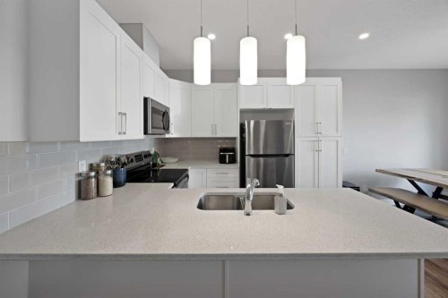 1167 Channelside Drive Sw, Airdrie, AB - Indoor Photo Showing Kitchen With Double Sink With Upgraded Kitchen