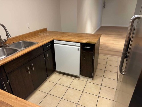 404 Acacia Drive Se, Airdrie, AB - Indoor Photo Showing Kitchen With Double Sink