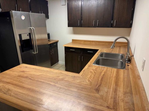 404 Acacia Drive Se, Airdrie, AB - Indoor Photo Showing Kitchen With Double Sink