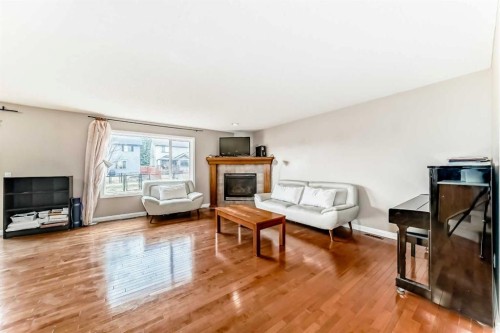 264 Everwillow Green Sw, Calgary, AB - Indoor Photo Showing Living Room With Fireplace