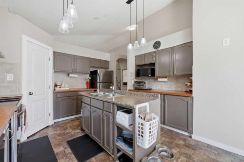 7 Chaparral Road Se, Calgary, AB - Indoor Photo Showing Kitchen With Double Sink