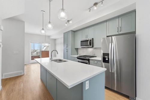84 Shawnee Common Sw, Calgary, AB - Indoor Photo Showing Kitchen With Stainless Steel Kitchen With Double Sink With Upgraded Kitchen