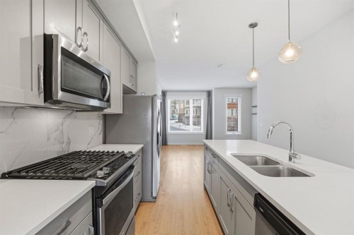 84 Shawnee Common Sw, Calgary, AB - Indoor Photo Showing Kitchen With Stainless Steel Kitchen With Double Sink With Upgraded Kitchen