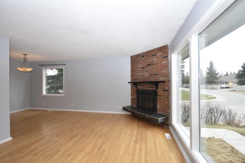 2604 106 Avenue Sw, Calgary, AB - Indoor Photo Showing Living Room With Fireplace