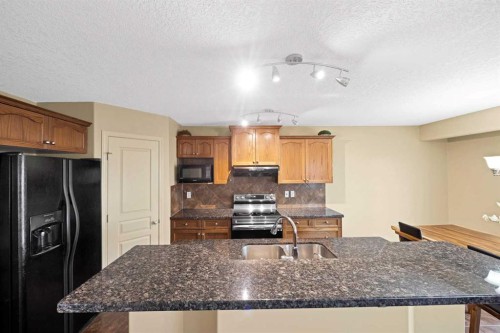 10 Bridlerange Circle Sw, Calgary, AB - Indoor Photo Showing Kitchen With Double Sink With Upgraded Kitchen