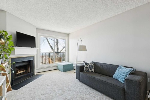 4308-385 Patterson Hill Sw, Calgary, AB - Indoor Photo Showing Living Room With Fireplace