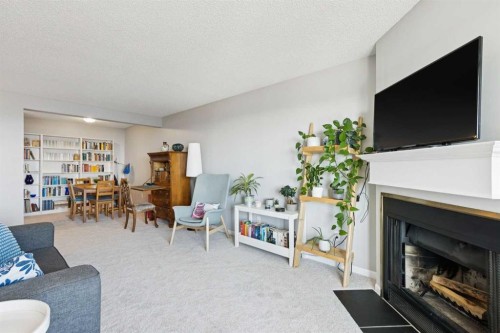 4308-385 Patterson Hill Sw, Calgary, AB - Indoor Photo Showing Living Room With Fireplace