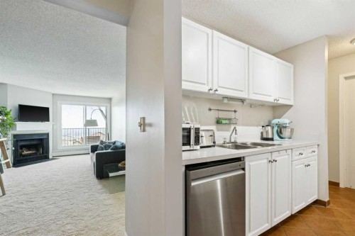 4308-385 Patterson Hill Sw, Calgary, AB - Indoor Photo Showing Kitchen With Fireplace With Double Sink