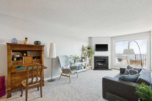 4308-385 Patterson Hill Sw, Calgary, AB - Indoor Photo Showing Living Room With Fireplace