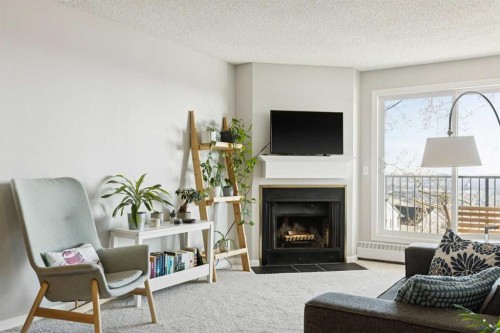 4308-385 Patterson Hill Sw, Calgary, AB - Indoor Photo Showing Living Room With Fireplace