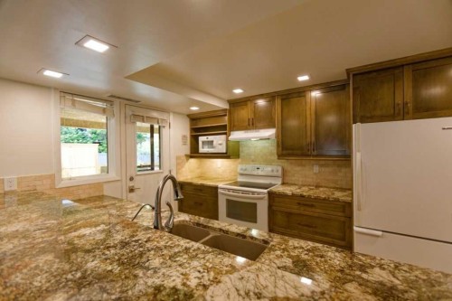 100-808 4 Avenue Nw, Calgary, AB - Indoor Photo Showing Kitchen With Double Sink