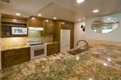 100-808 4 Avenue Nw, Calgary, AB - Indoor Photo Showing Kitchen With Double Sink