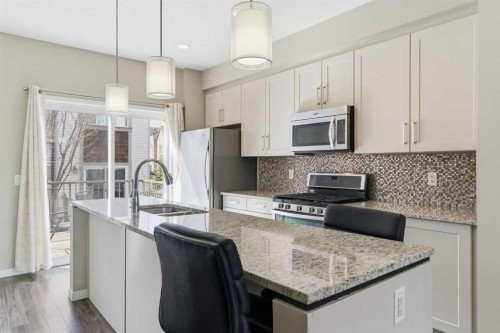 150 Copperpond Villas Se, Calgary, AB - Indoor Photo Showing Kitchen With Double Sink With Upgraded Kitchen