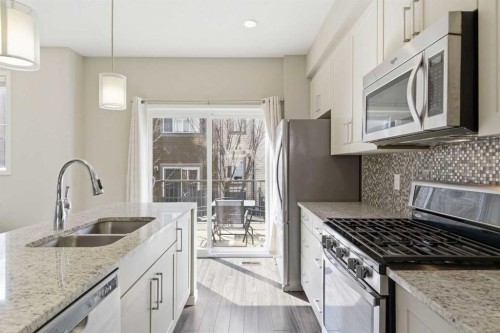 150 Copperpond Villas Se, Calgary, AB - Indoor Photo Showing Kitchen With Stainless Steel Kitchen With Double Sink With Upgraded Kitchen