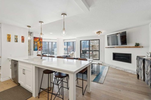 707-320 Meredith Road Ne, Calgary, AB - Indoor Photo Showing Kitchen With Fireplace With Upgraded Kitchen
