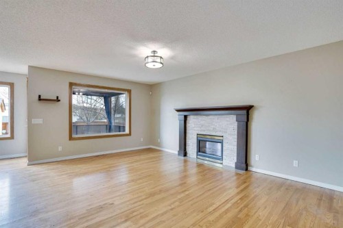 143 Country Hills View Nw, Calgary, AB - Indoor Photo Showing Living Room With Fireplace