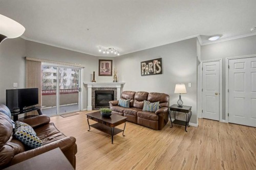 408-777 3 Avenue Sw, Calgary, AB - Indoor Photo Showing Living Room With Fireplace
