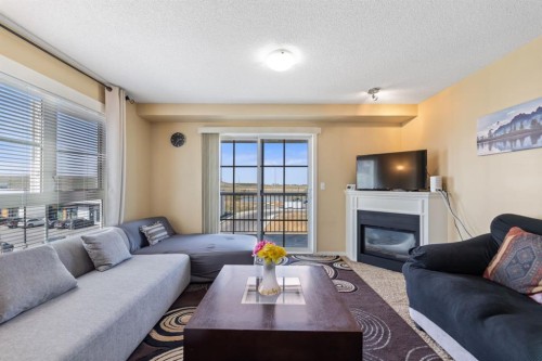 3306-279 Copperpond Common Se, Calgary, AB - Indoor Photo Showing Living Room With Fireplace
