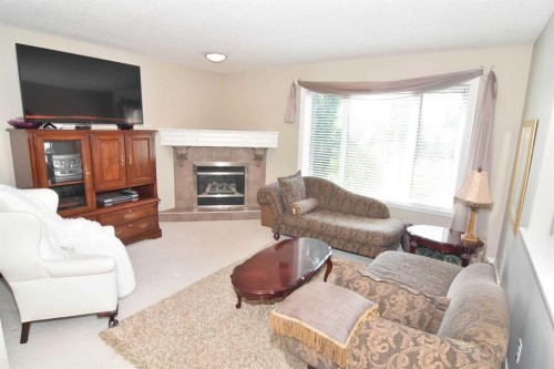 148 Scenic View Close Nw, Calgary, AB - Indoor Photo Showing Living Room With Fireplace
