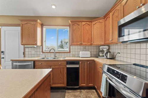 65 Canoe Circle Sw, Airdrie, AB - Indoor Photo Showing Kitchen With Stainless Steel Kitchen With Double Sink