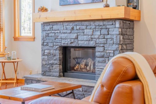 302-801 Benchlands Trail, Canmore, AB - Indoor Photo Showing Living Room With Fireplace