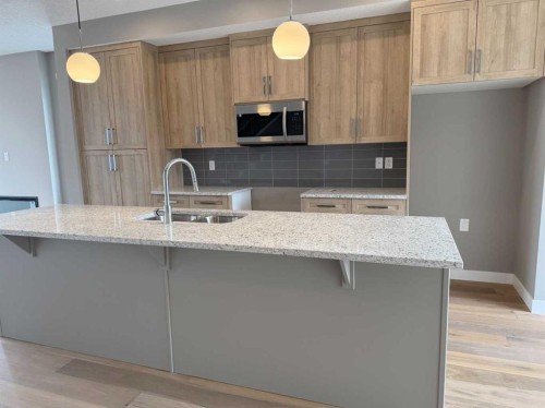 24 Sundown Place, Cochrane, AB - Indoor Photo Showing Kitchen With Double Sink With Upgraded Kitchen