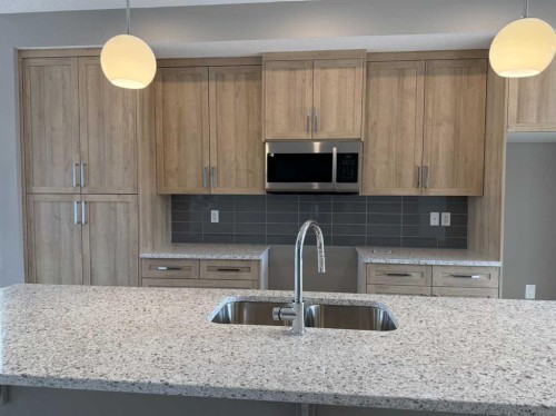 24 Sundown Place, Cochrane, AB - Indoor Photo Showing Kitchen With Double Sink With Upgraded Kitchen
