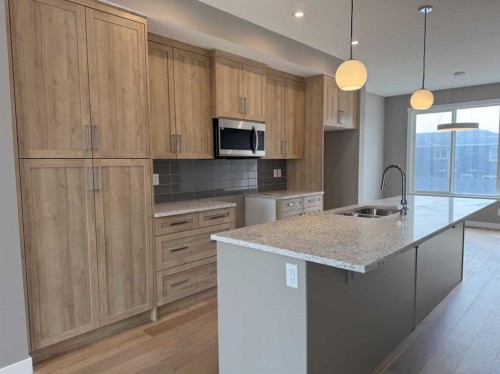24 Sundown Place, Cochrane, AB - Indoor Photo Showing Kitchen With Upgraded Kitchen