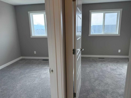24 Sundown Place, Cochrane, AB - Indoor Photo Showing Other Room