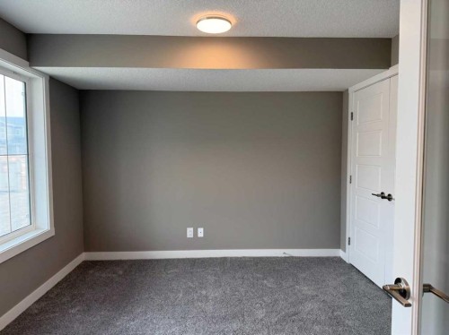 24 Sundown Place, Cochrane, AB - Indoor Photo Showing Other Room