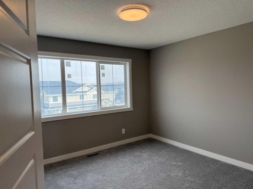 24 Sundown Place, Cochrane, AB - Indoor Photo Showing Other Room