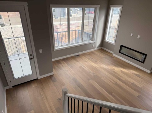 24 Sundown Place, Cochrane, AB - Indoor Photo Showing Other Room With Fireplace