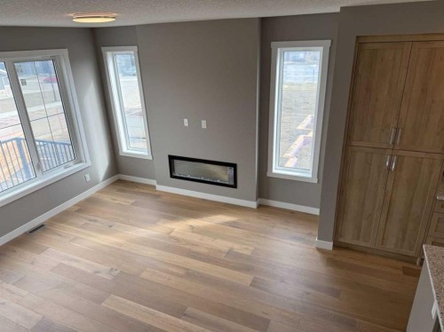 24 Sundown Place, Cochrane, AB - Indoor Photo Showing Living Room With Fireplace