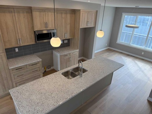 24 Sundown Place, Cochrane, AB - Indoor Photo Showing Kitchen With Double Sink