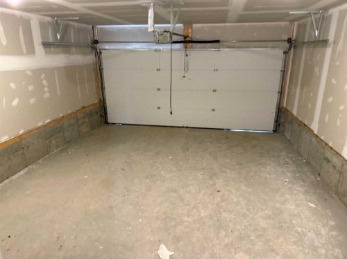 24 Sundown Place, Cochrane, AB - Indoor Photo Showing Garage